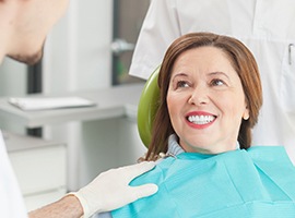 Smiling older woman in dental chair during restorative dentistry visit