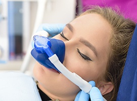 Young woman in dental chair with nitrous oxide sedation mask