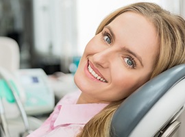 Smiling blonde woman in dental chair