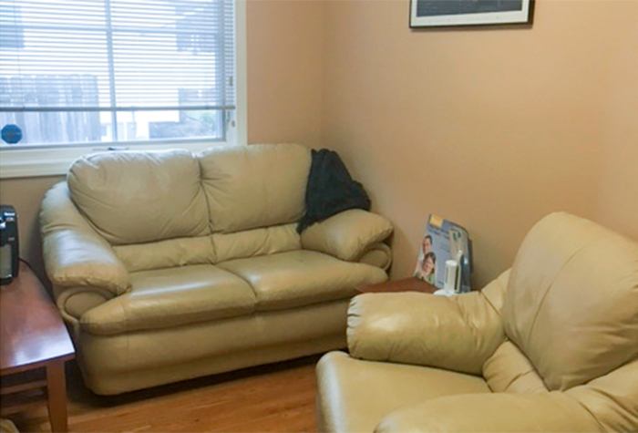 Comfortable couch and armchair in dental office waiting room