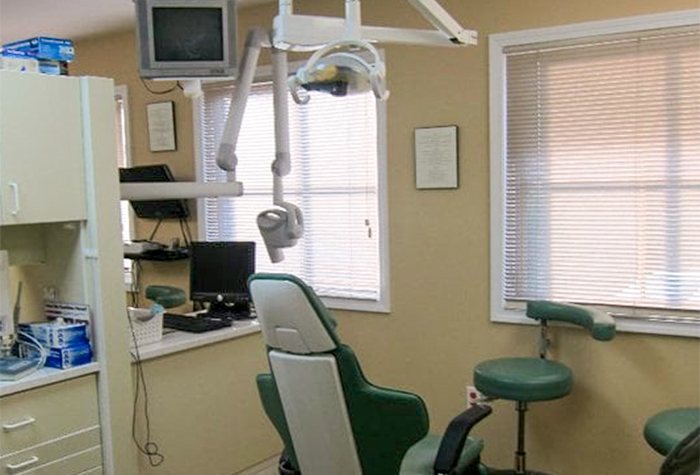 Dental exam room with sunlight streaming in through two windows