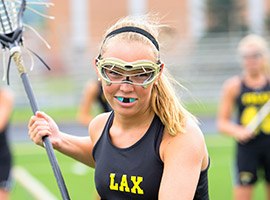 Teen girl with sportsguard playing lacrosse